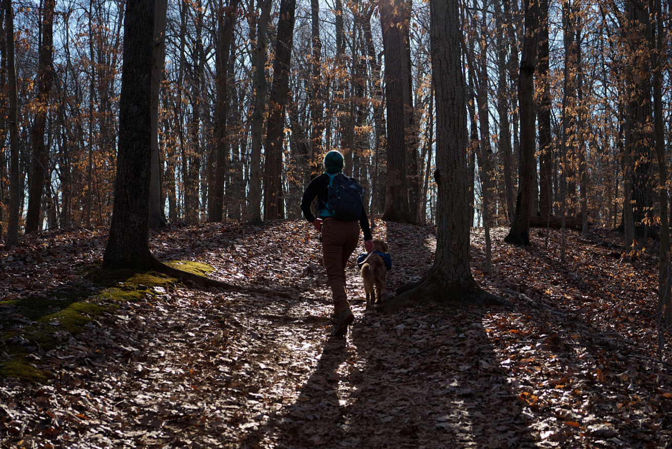 Picture of Anna hiking with her dog, Mo